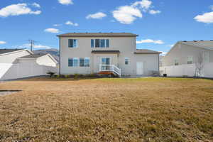 Rear view of house featuring a fenced backyard, stucco siding, and a patio