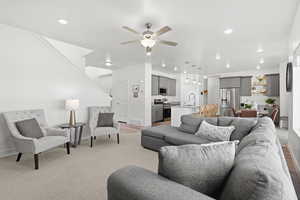 Living area with ceiling fan and a chandelier