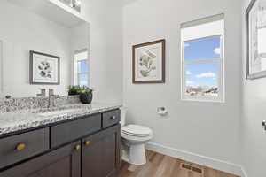 Half bathroom featuring vanity and light wood-style flooring