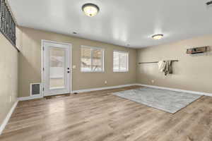 Workout room featuring light wood-style flooring
