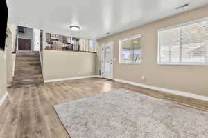 Entryway featuring stairway and light wood finished floors