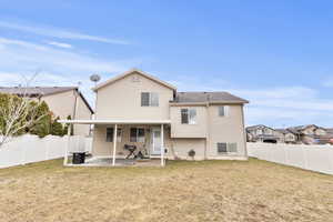 Rear view of property featuring a fenced backyard, a patio, and a residential view