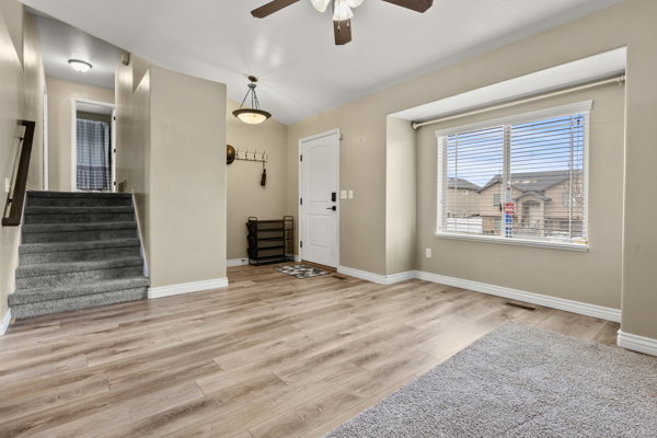 Foyer featuring light wood-type flooring and a ceiling fan
