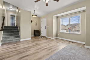 Foyer featuring light wood-type flooring and a ceiling fan