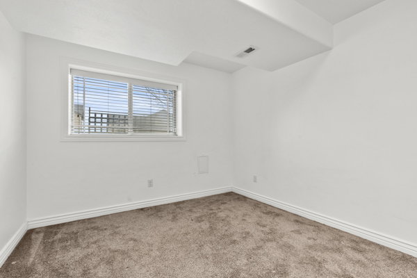 Unfurnished room with carpet and baseboards