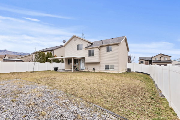Back of property featuring a patio and a fenced backyard