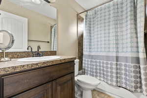 Bathroom featuring vanity and shower / bath combo with shower curtain