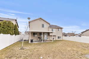 Rear view of property with a patio area and a fenced backyard