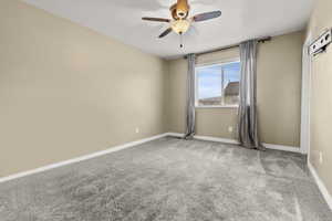Empty room with light carpet and ceiling fan