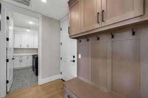 Mudroom with light wood-style flooring and recessed lighting