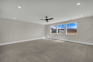 Unfurnished room featuring carpet floors, ceiling fan, and recessed lighting