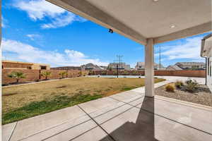 Fenced backyard with a patio area and a residential view