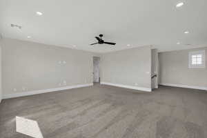 Empty room with ceiling fan, light carpet, and recessed lighting