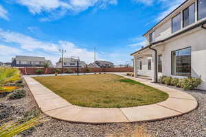 Fenced backyard featuring a residential view