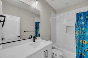 Bathroom with vanity and shower / bath combination with curtain