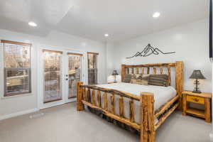 Bedroom featuring light carpet, french doors to outside, and recessed lighting