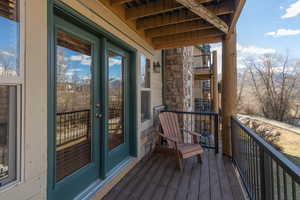 Balcony featuring french doors and mountain views