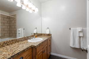 Bathroom featuring vanity and tub / shower combination