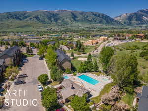 Aerial overview of property's location with mountains and a pool area