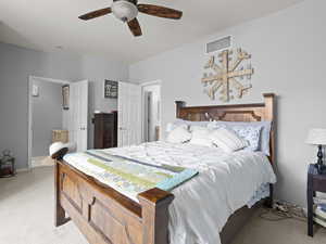 Bedroom featuring light carpet and ceiling fan