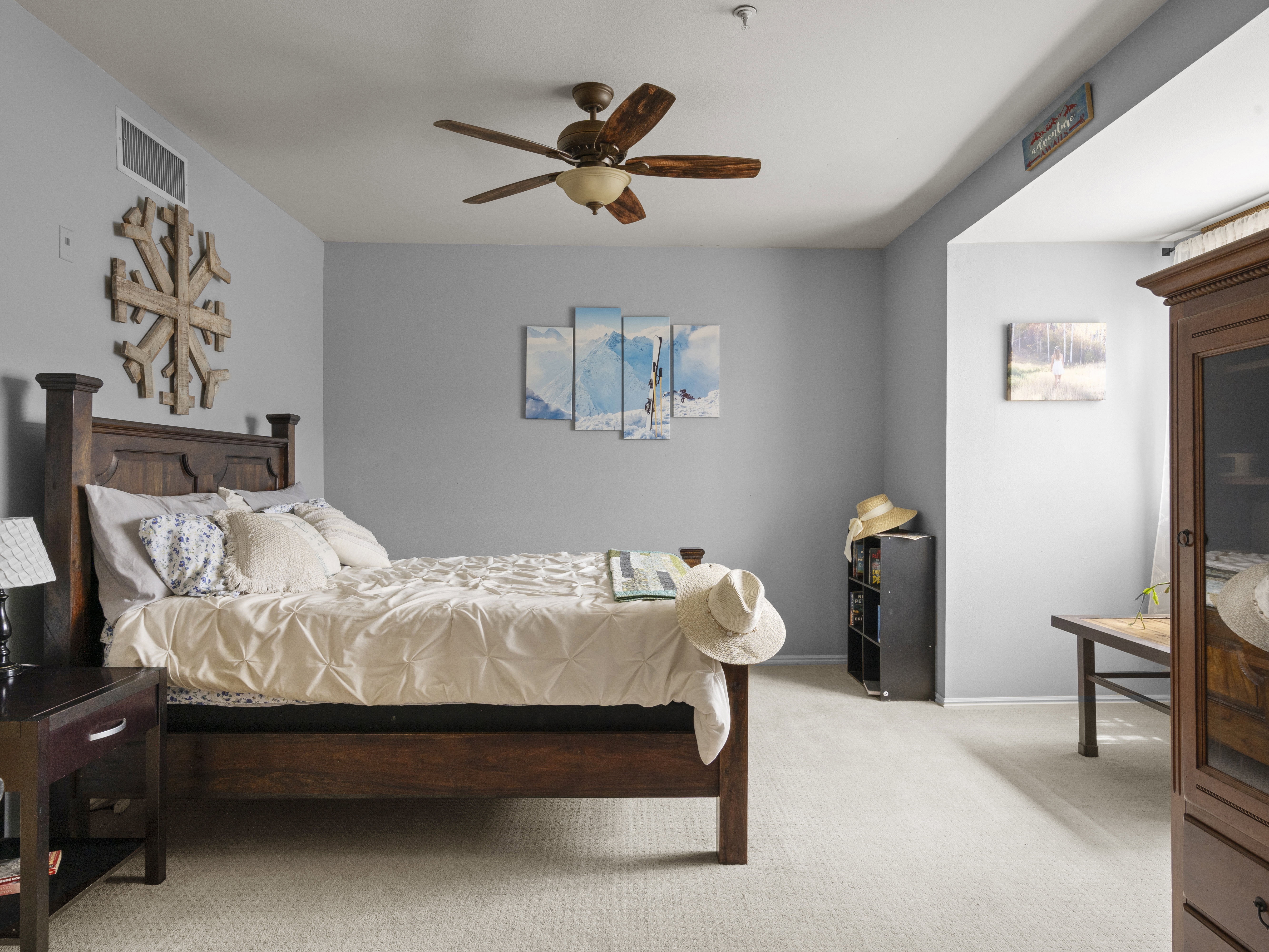 Bedroom featuring light colored carpet and a ceiling fan