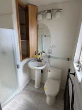 Bathroom featuring toilet and a stall shower