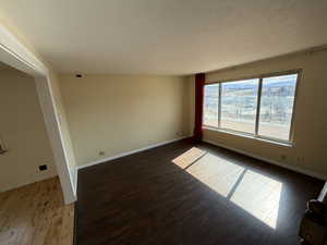 Empty room featuring baseboards and light wood-style flooring