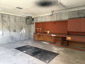 Garage with a workshop area and a heating unit