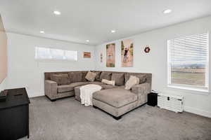Living area with carpet floors, recessed lighting, and healthy amount of natural light
