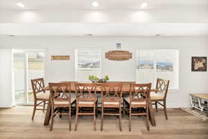 Dining space with plenty of natural light, light wood finished floors, and recessed lighting
