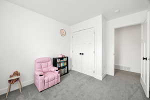 Sitting room with carpet flooring and baseboards