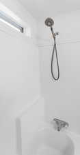 Bathroom view of bathtub / shower combination
