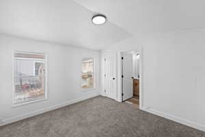 Unfurnished bedroom featuring carpet floors and connected bathroom