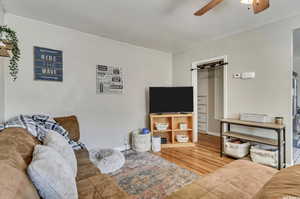 Living room with ceiling fan and wood finished floors