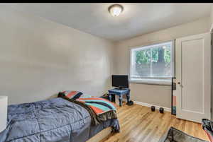 Bedroom featuring light wood finished floors and baseboards
