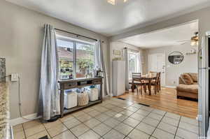 Entrance foyer with ceiling fan and light tile patterned floors