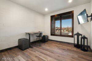 Home office featuring wood finished floors and recessed lighting