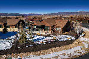 Snowy aerial view featuring a mountain view and a residential view