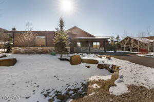 View of snow covered rear of property