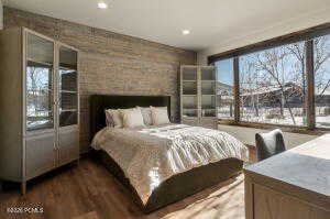 Bedroom featuring wood finished floors, recessed lighting, and multiple windows