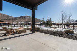 Snow covered patio featuring a patio and a mountain view