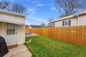 Fenced backyard featuring a patio