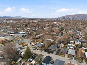 Aerial overview of property's location with a mountain backdrop and nearby suburban area