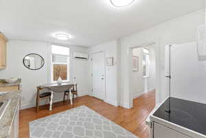 Office area featuring light wood finished floors and a textured ceiling