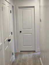 Corridor featuring light wood-type flooring