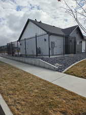 View of property exterior featuring board and batten siding and a shingled roof