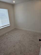 Unfurnished room featuring carpet flooring and recessed lighting