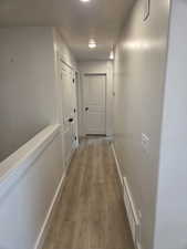 Hallway with dark wood-style floors and baseboards