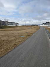 View of asphalt road with a residential view