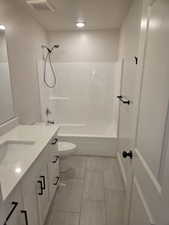 Bathroom with vanity and shower / tub combination